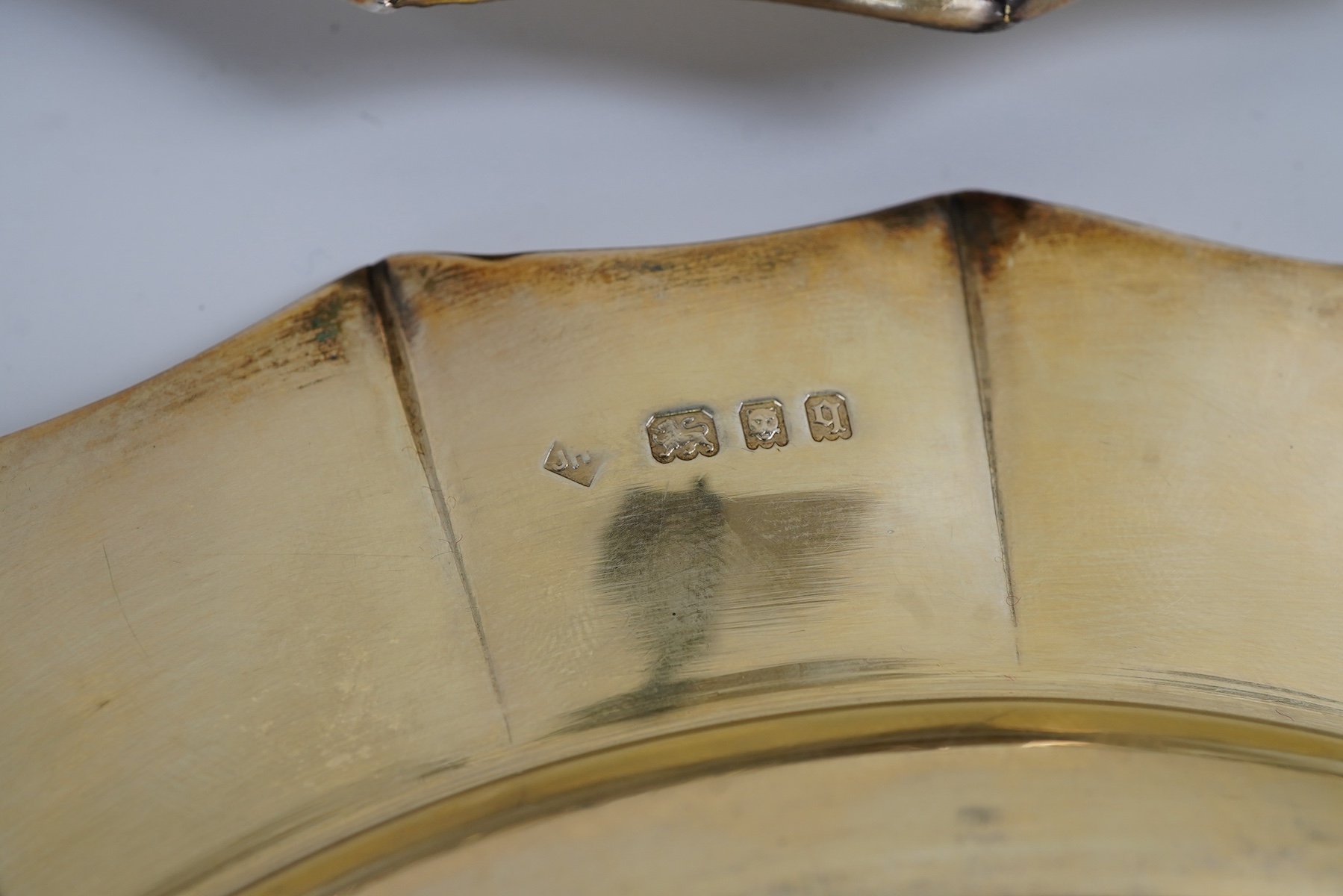 A set of twelve George V silver gilt side plates by J.S. Harman & Co